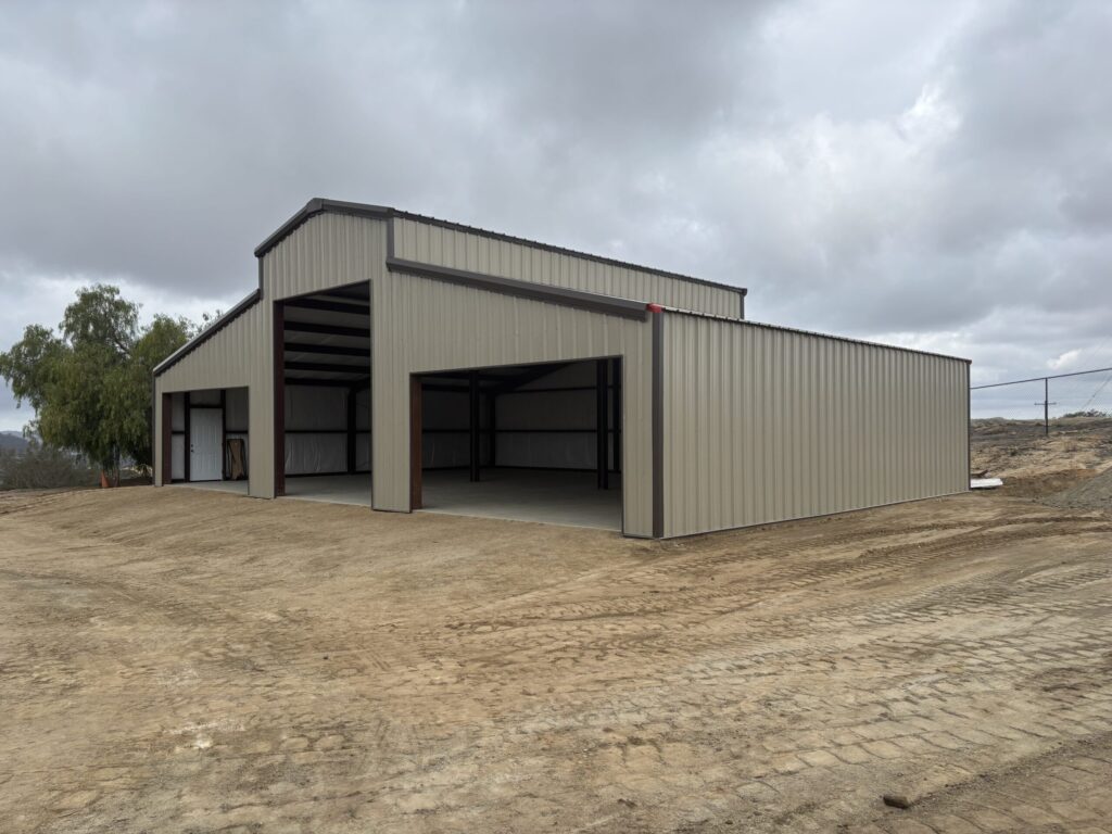 Metal garage builders finishing a custom garage in Arkansas.