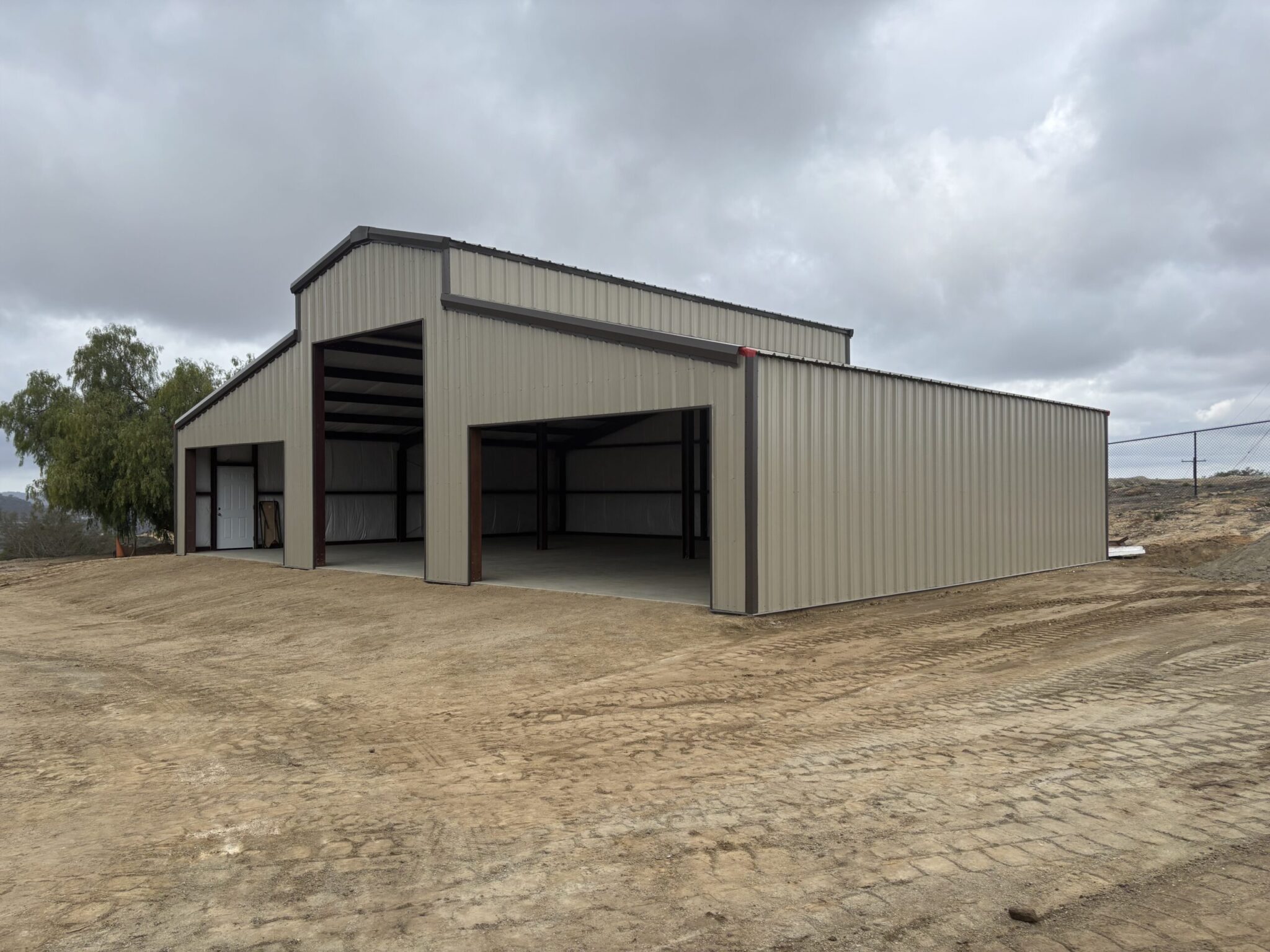 Metal garage builders finishing a custom garage in Arkansas.